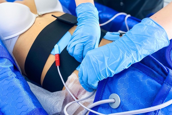Client relaxing in a pressotherapy suit during a wellness session